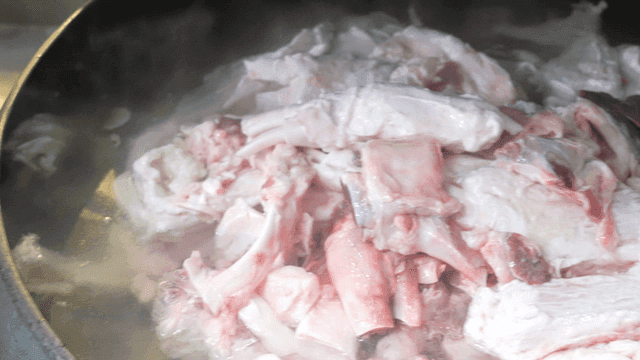 Beef tendon boiled in large pot