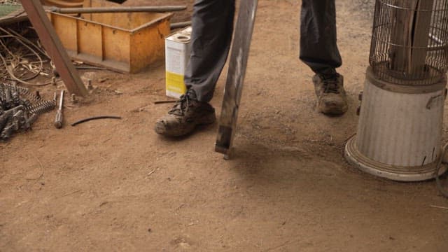 Worker moves a heavy metal cover