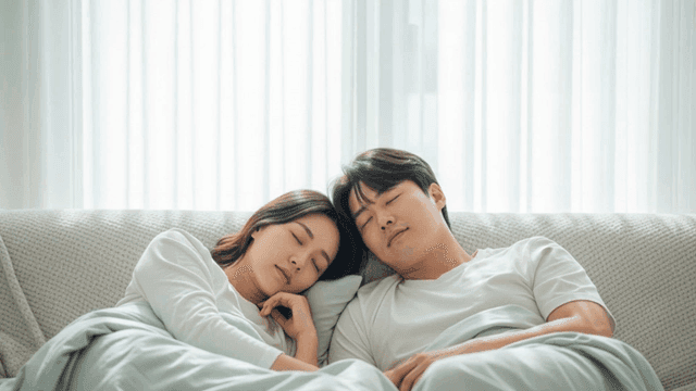 Couple sleeping peacefully on sofa
