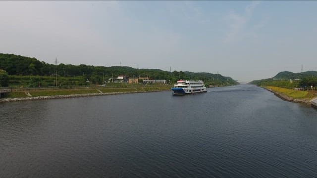 Cruise Ship Sailing Down a Serene River