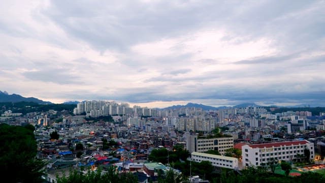 A sprawling cityscape under a cloudy sky