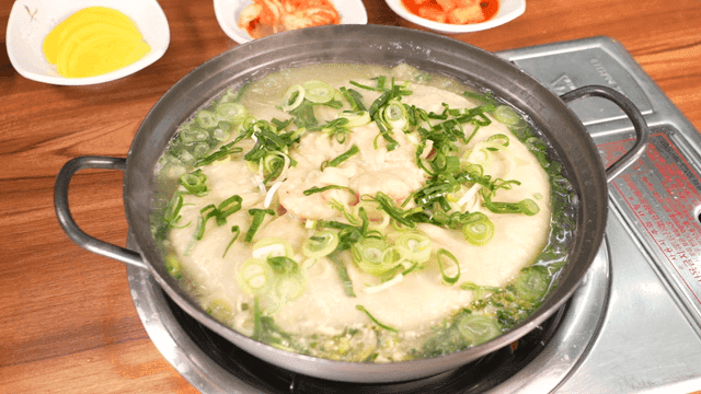 Large dumpling soup boiling in pot
