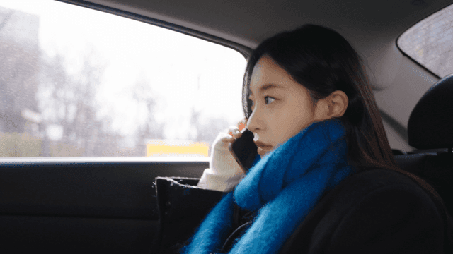 Woman talking on the phone in a taxi