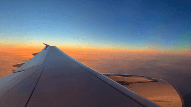 Airplane wing with sunset sky