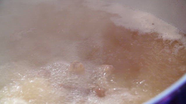 Chicken boiling in a big pot