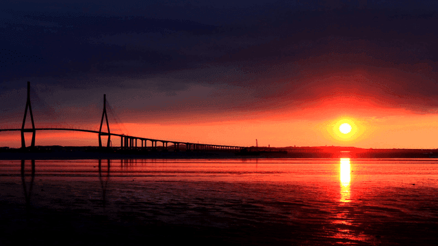 Bridge over serene sunset.