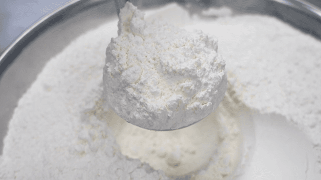 그릇에서 밀가루를 퍼내는 장면