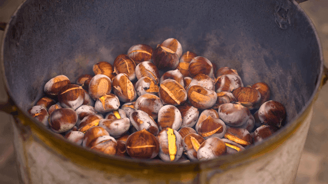 Chestnuts roasting in a metal pot