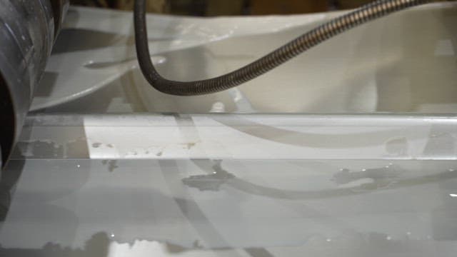 Metal sheet being processed in a factory