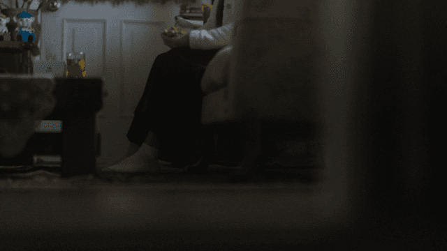 Middle-aged woman sitting on cozy living room sofa