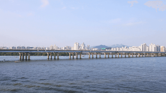 Bridge over river with view of city skyline