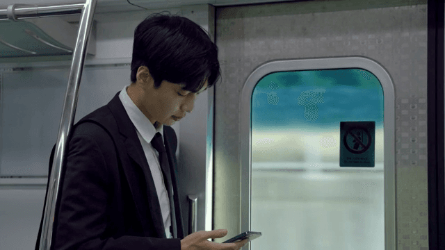 Office worker using smartphone on subway