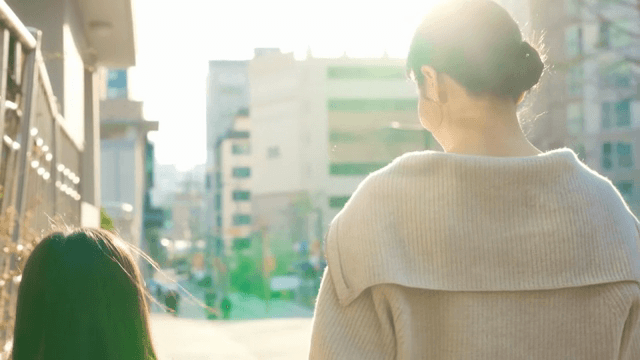 Child walking to school with her mother