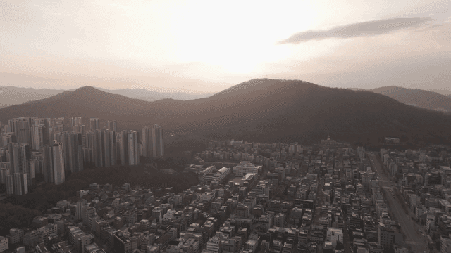 Mountains and city scenery at sunset.