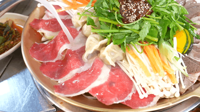 Boiled beef slices hot pot filled with fresh ingredients