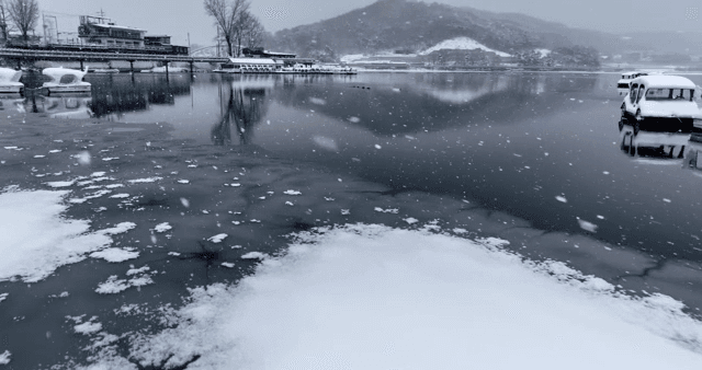 Snow-covered lake with pedal boats
