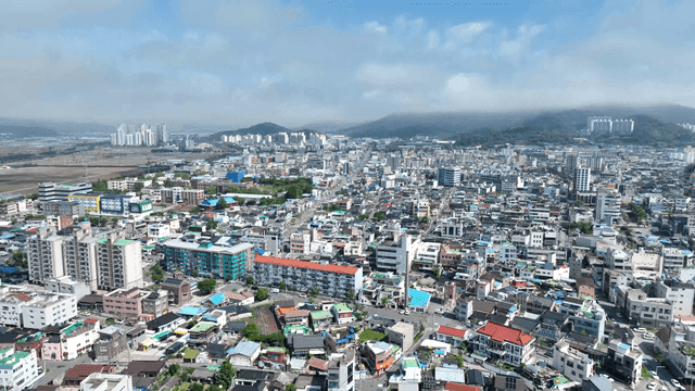 Panoramic view of residential area with mountains in distance