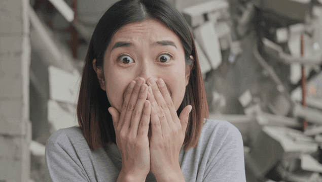 Shocked woman inside collapsing building