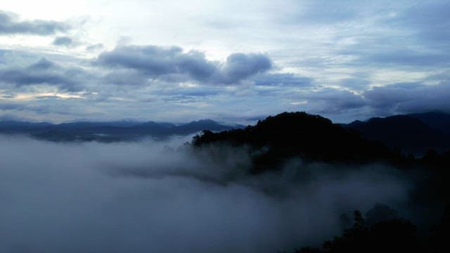 Misty mountains under a cloudy sky