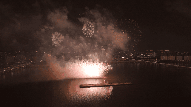 Glittering fireworks festival over river and city center