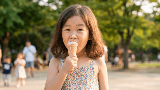 Girl eating ice cream in park