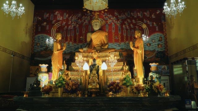 Ornately decorated altars and Buddhist statues inside the temple