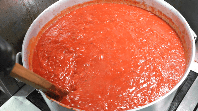 Tomato sauce stirred in large pot