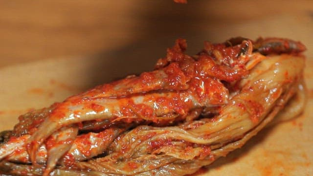 Kimchi being prepared on a wooden board