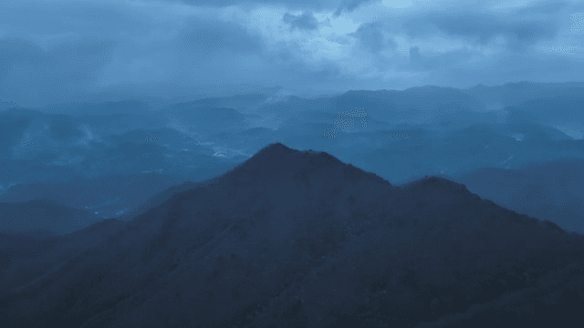 Misty mountains under a cloudy sky