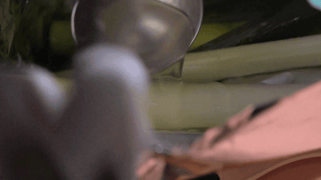 Leek wrapped in foil as broth is being poured