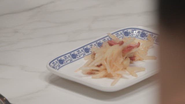 Plate of stir-fried shredded potatoes with meat