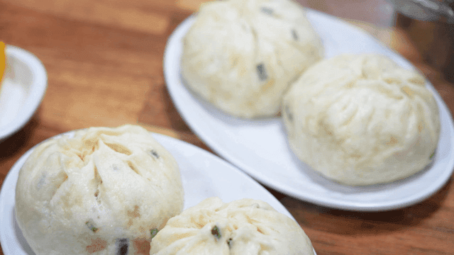 Steamed dumplings on white plate