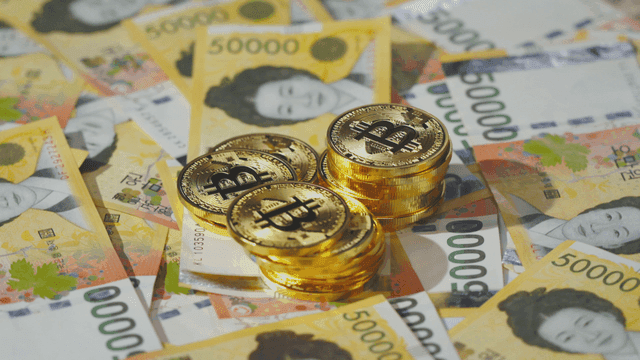 Bitcoin coins on Korean won bills
