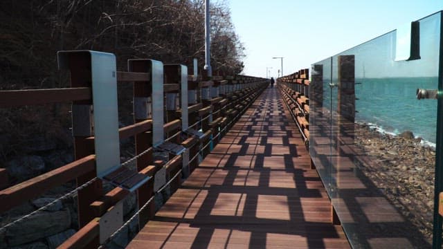 Wooden coastal walkway next to the beach on a sunny afternoon