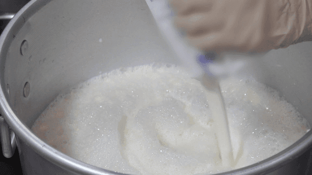 Milk being poured into a pot