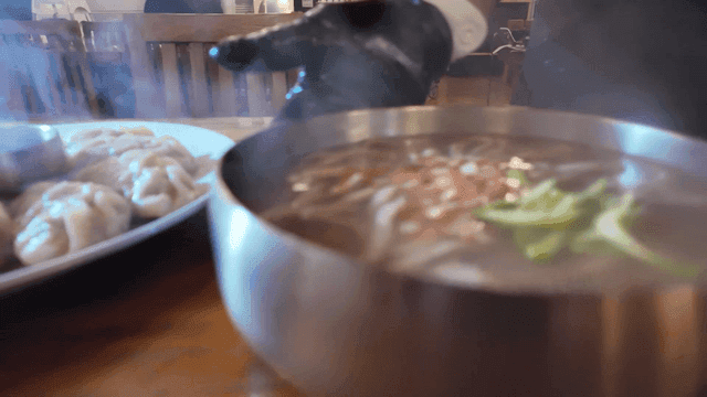 Table topped with dumplings and kalguksu