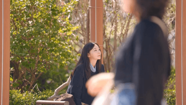Woman sitting on park bench waiting for someone