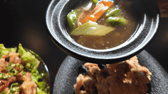 Bowl containing tangsuyuk sauce with vegetables