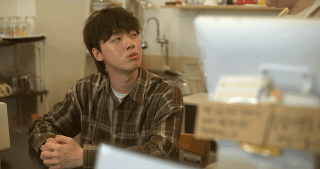 Young men talking at cozy cafe counter