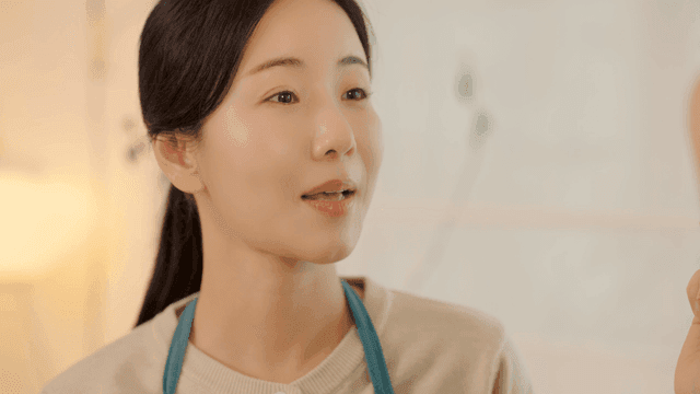 Daughter applying lip gloss to her mother