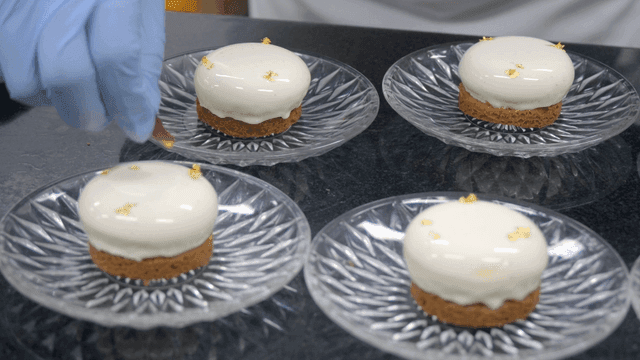 Decorating elegant white desserts on plates