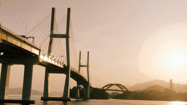 Bridge over quiet river at sunset