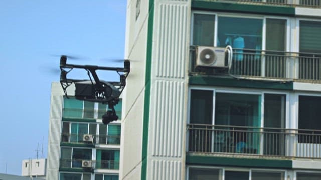 Drone flying by residential buildings