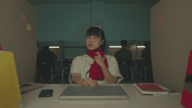 독서실에서 빨간 스카프를 두르고 더워하는 여학생