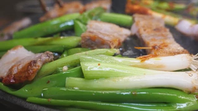 Green onions grilled sizzling with pork belly