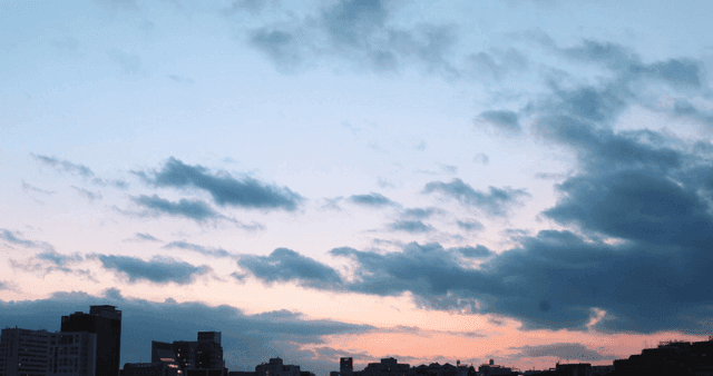 City skyline under a colorful sunset