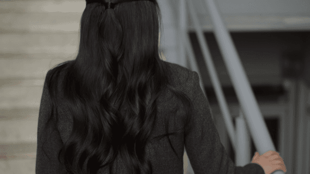 Back view of woman climbing stairs