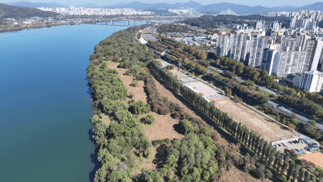 River alongside a city with tall buildings