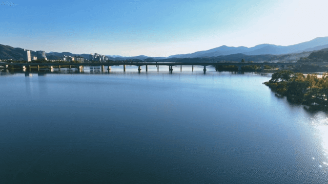 Tranquil lake with bridges and mountains