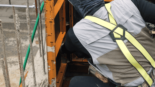 Worker adjusting construction framework